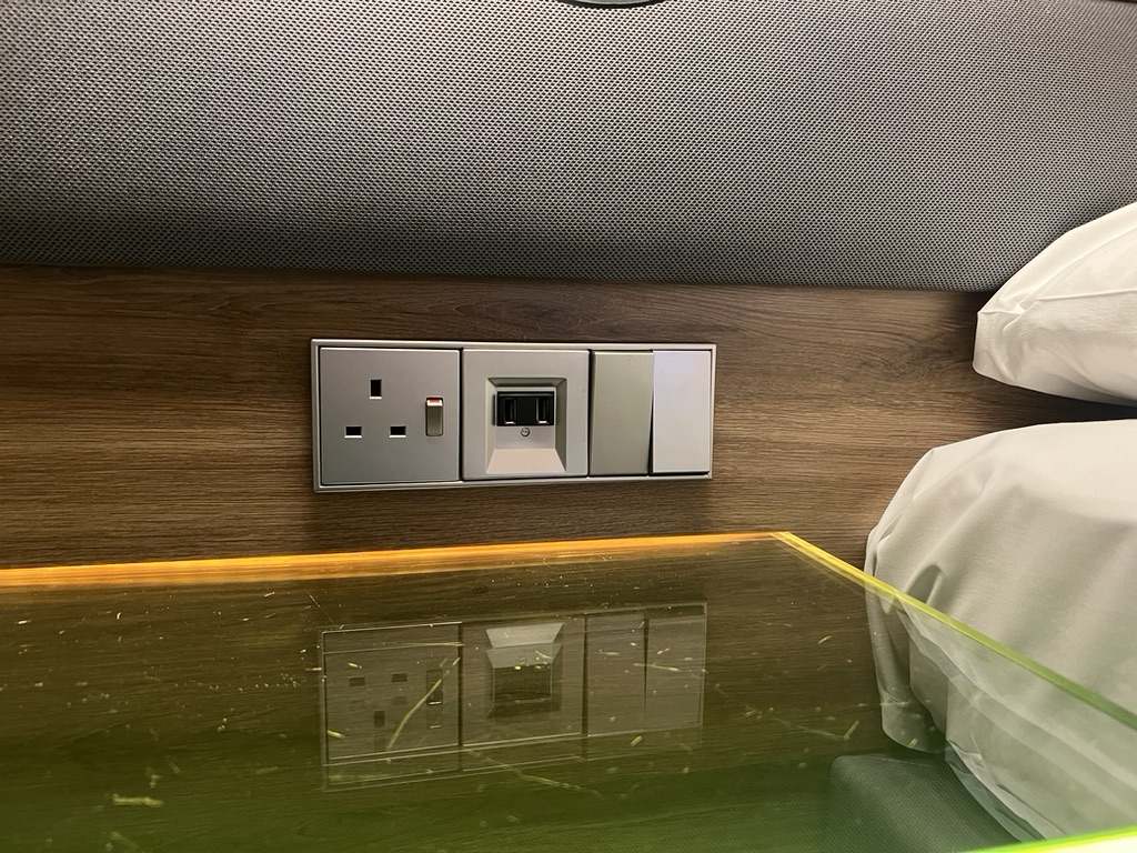 plug sockets on the wall next to bed